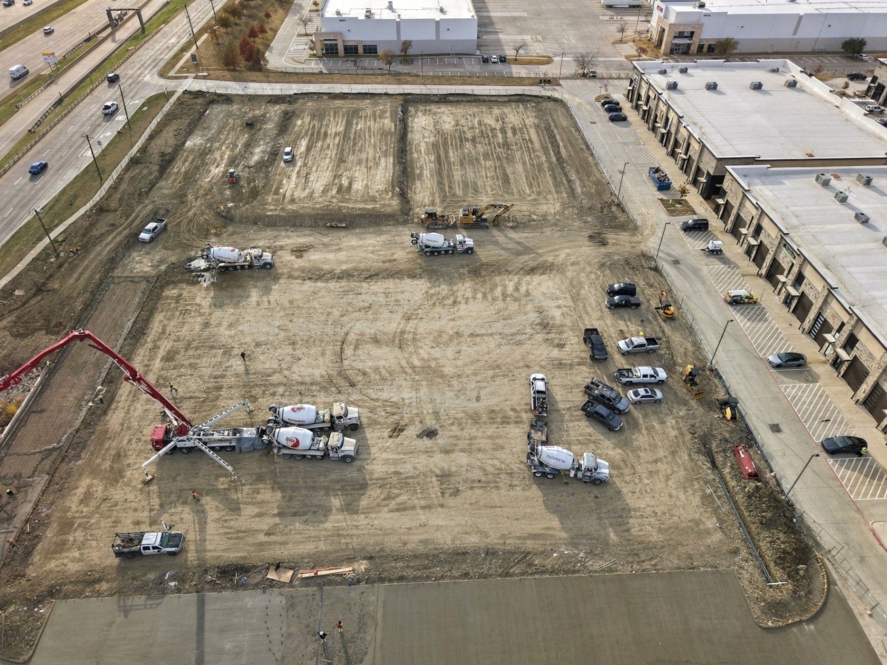 Aerial construction documentation showing active site conditions and surrounding property context.