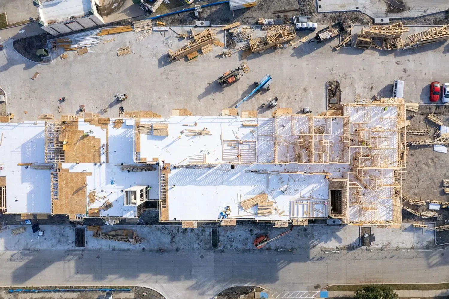 Aerial view of a DFW commercial construction site showing structural layout and progress